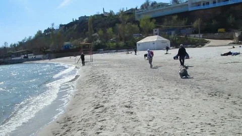 The Sandy Beach In The Spring. Sunny Day. People Walk Along The Beach. Stock-Footage 88992665