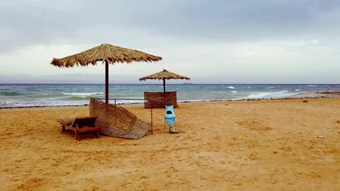Sandy beach with straw umbrellas Stock Footage 146076356