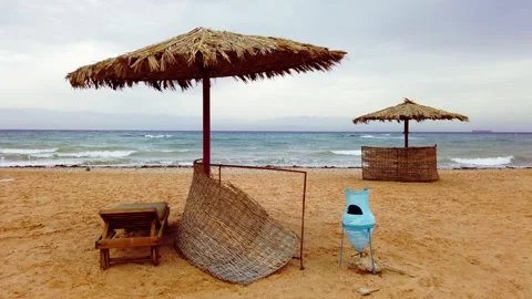 Sandy beach with straw umbrellas Stock Footage 146076718