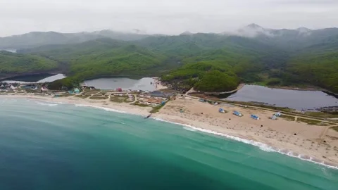 Sandy beach of a summer resort with a blue and clear sea, no people, footage Stock Footage 246899721