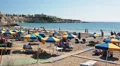 Sandy beach with sunbeds and parasols full of people, Coral Bay, Peyia, Cyprus HD Footage