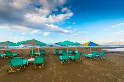 Sandy beach with sunbeds Stock Photos