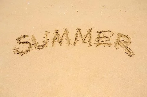 Sandy beach on sunny day with text "summer", vacation holiday background. W.. Stock Photos