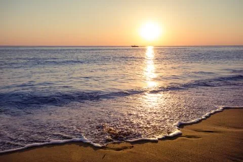 Sandy beach at sunset Stock Photos