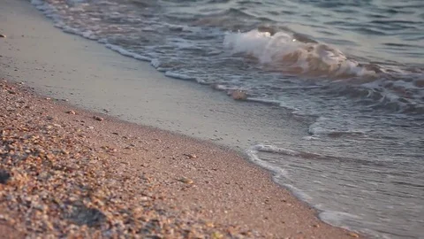 Sandy beach at sunset, small waves, pebbles, Black sea Видео 82697927