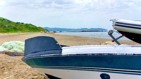 On the sandy beach there are two boats pulled ashore. Stock Footage 249355915