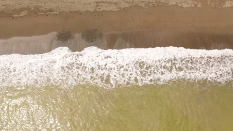 Sandy beach with volcanic sand, top view. Stock Footage 126523258