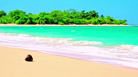 Sandy beach washed by white-crested waves of azure tropical sea Video stock 72783488