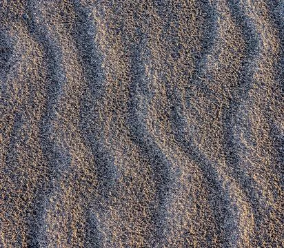 A sandy beach with a wave pattern Foto stock