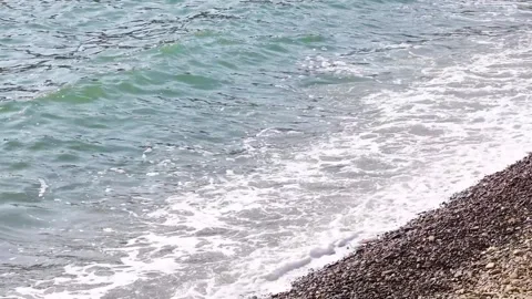 Sandy beach with waves, daylight Stock Footage 303391115