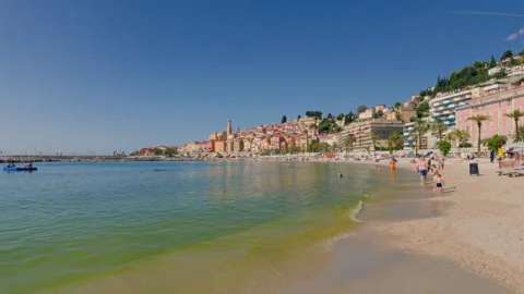 Sandy Beach Waves Meet Colorful Old Town Stock Footage 346860332