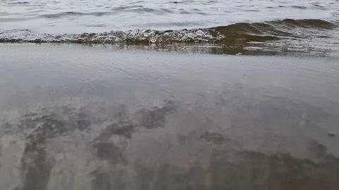 Sandy beach with waves. Recreation at the sea, river Stock Footage 262428043