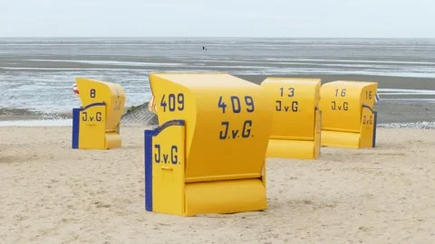 Sandy beach with yellow beach chairs Stock Footage 251625432