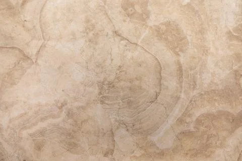 Sandy beige marble surface with subtle patterns and textures highlighted by Stock Photos