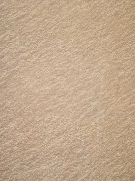Sandy beige surface shows a textured granular pattern and rough finish under  Stock Photos