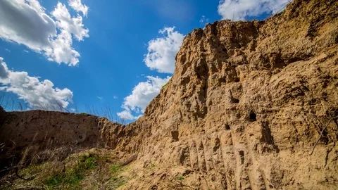 Sandy cliff against the blue sky with clouds. Stock Footage 74613244
