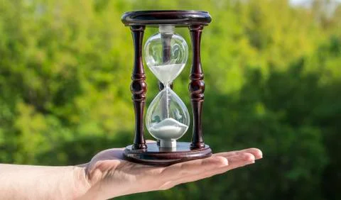 Sandy clock in a man's hand Stock Photos