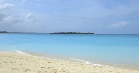 Sandy coast washed by a quiet wave of azure color. Zanzibar Island, Tanzania Stock Footage 156822680