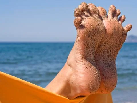 Sandy crazy woman toes  on the beach Stock Photos