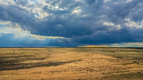Sandy desert under dense cloudy sky, outdoor natural time lapse scene Stock Footage 147483964