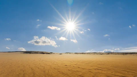 Sandy desert under sparkle sun on cloudy sky 스톡 동영상 150680530