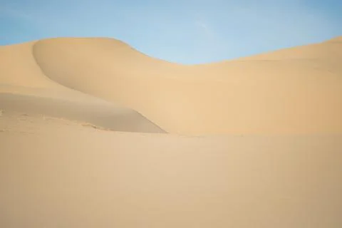 Sandy dune against blue Stock Photos