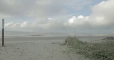 Sandy dunes and waves on a beach Video stock 76676933