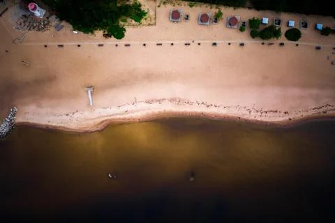 Sandy empty beach and contour of big lake in sunset. Top down directly above. Stock Photos