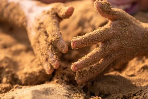 Sandy hands of a child Stock Photos