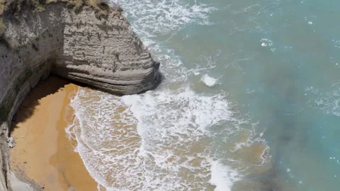 Sandy high cliff and coast of blue and turquoise mediterranean sea with waves. Stock Footage 279554627