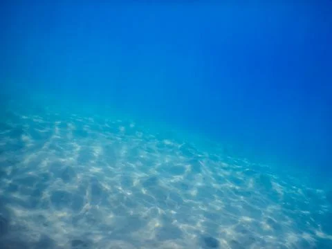 Sandy hills with reflection from the sun in the red sea Stock Photos