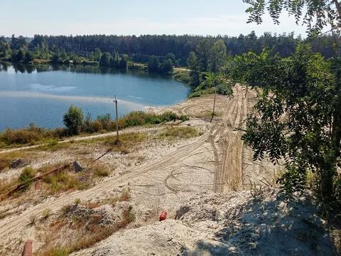 Sandy Lakeside Landscape with Forest Background Stock Photos