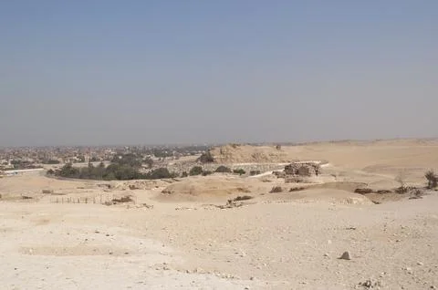 Sandy landscape in the desert in Cairo in front of the famous Egyptian pyramids Stock Photos