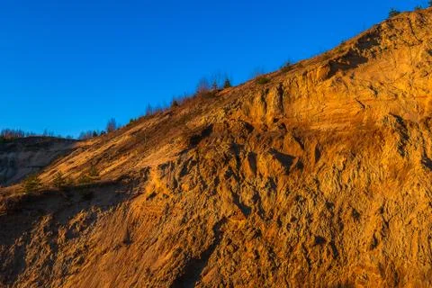Sandy mountain against the blue cloudless sky. Stock Photos