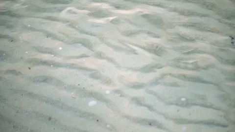 Sandy Ocean Floor Ripple Pattern Seen Through Shallow Water Near Shore From Top Stock Footage 120331419
