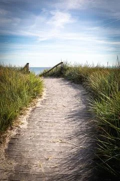 Sandy path leads over the dunes to the Baltic Sea beach Stock Photos
