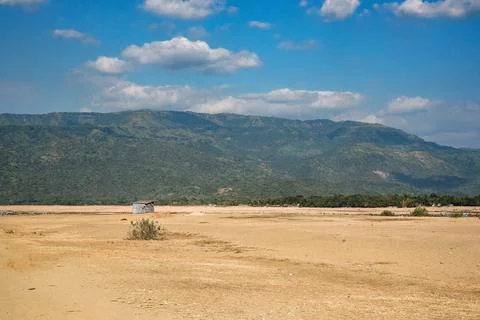 Sandy Plain with Distant Mountains Under a Clear Blue Sky Stock Photos
