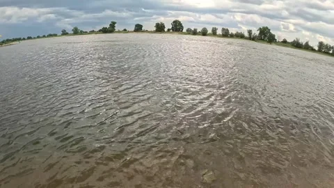 Sandy River Shore with Dramatic Clouds and Calm Water, Summer Nature Landscape i Stock Footage 339569327
