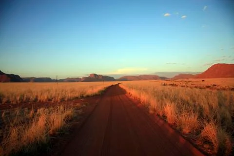 Sandy road going to a farm Stock Photos