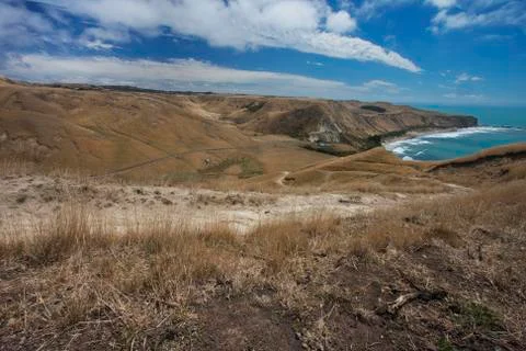 Sandy road winding down the hill. Stock Photos