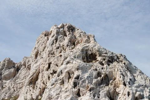 Sandy rock against a backdrop of blue sky Stock Photos
