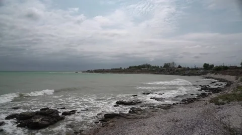 Sandy Rocky Beach with Clouds 4K Stock Footage 66562617