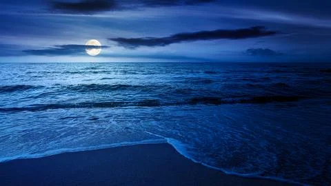 Sandy sea beach background on cold summer night Stock-Fotos