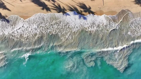 Sandy sea beach with waves as background from above.Turquoise on gold. Stock Footage 250143878