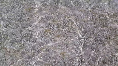 The sandy seabed is visible through clear and clear sea water. Stock Footage 127846559