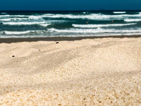 Sandy seashore, calm soft waves at sea, sunny weather, blue sky, white clouds Stock Photos