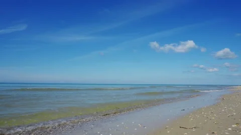 Sandy seashore or ocean. Clear water in the warm summer sun. A place of rest  Stock Footage 155529658