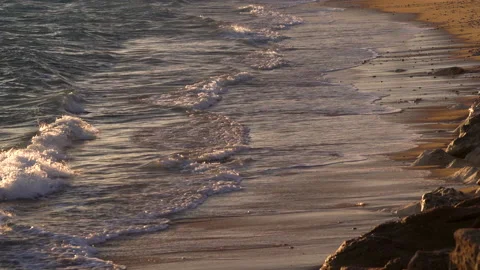 Sandy seashore with small waves in the evening at Sunset in Cadiz Spain. Video stock 235632976