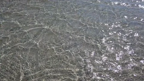 Sandy shallow water, beach. Weak ripples on the surface of the water as a bac Stock-Footage 140731598