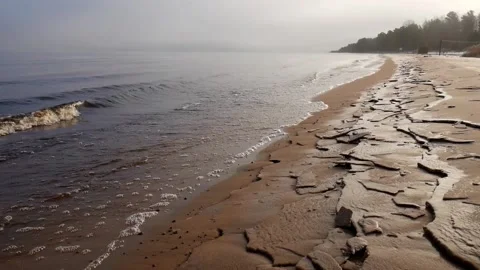 Sandy shore covered with ice. Beautiful dawn. Morning fog. Stock Footage 124269439